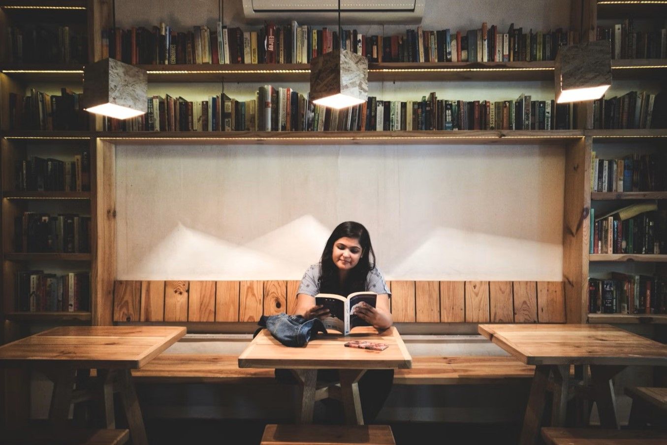 Credit: Praveen Gupta on Unsplash.com. 'woman reading book inside library' https://unsplash.com/photos/woman-reading-book-inside-the-library-YhfxJpa_Ch0